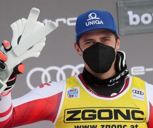 epa08911242 Winner Matthias Mayer of Austria celebrates on the podium after the Men's Downhill race at the FIS Alpine Skiing World Cup in Bormio, Italy, 30 December 2020.  EPA/ANDREA SOLERO