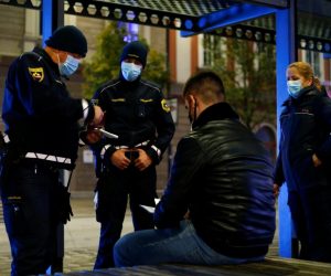 Slovenia starts a nightly curfew from 9 p.m. to 6 a.m as to curb the rising of the coronavirus disease (COVID-19) cases in the country, in Ljubljana Police officers check the documents of a man as Slovenia starts a nightly curfew from 9 p.m. to 6 a.m as part of a state of emergency called to curb the rising of the coronavirus disease (COVID-19) cases in the country, in Ljubljana, Slovenia, October 20, 2020. REUTERS/Borut Zivulovic BORUT ZIVULOVIC