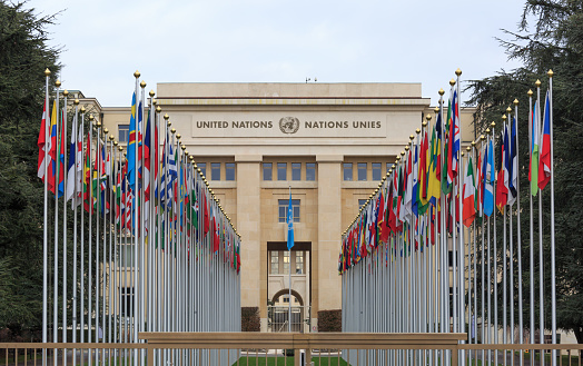 GENEVA, SWITZERLAND - December 17, 2017: Allee des Nations (Avenue of Nations) of the United Nations Palace in Geneva, with the flags of the member countries.