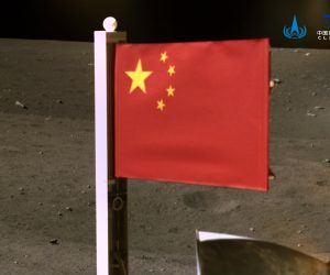 epa08861587 A handout photo made available by the China National Space Administration (CNSA) on 04 December 2020 and taken by a panoramic camera installed on the lander-ascender combination of the probe, before the ascender blasted off from the moon with lunar samples, shows China's national flag unfurled from the Chang'e-5 probe on the moon on 03 December 2020.  EPA/CHINA NATIONAL SPACE ADMINISTRATION / HANDOUT HANDOUT EDITORIAL USE ONLY HANDOUT EDITORIAL USE ONLY/NO SALES