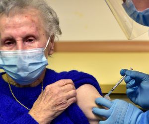epa08905639 A Slovenian patient (L) receives a vaccine of the Pfizer-BioNTech against the COVID-19 at the Home for Elderly people Fuzine, in Ljubljana, Slovenia, 27 December 2020.  EPA/IGOR KUPLJENIK