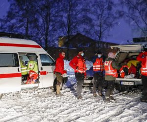epa08910836 Rescue workers from The Red Cross prepare for rescue operation at the site of a big landslide in the village Ask, some 40 km north of Oslo, Norway, 30 December 2020. According to the police at least five people were injured and several people are still missing after a big landslide hit a residential area in the village of Ask.  EPA/TERJE BENDIKSBY  NORWAY OUT