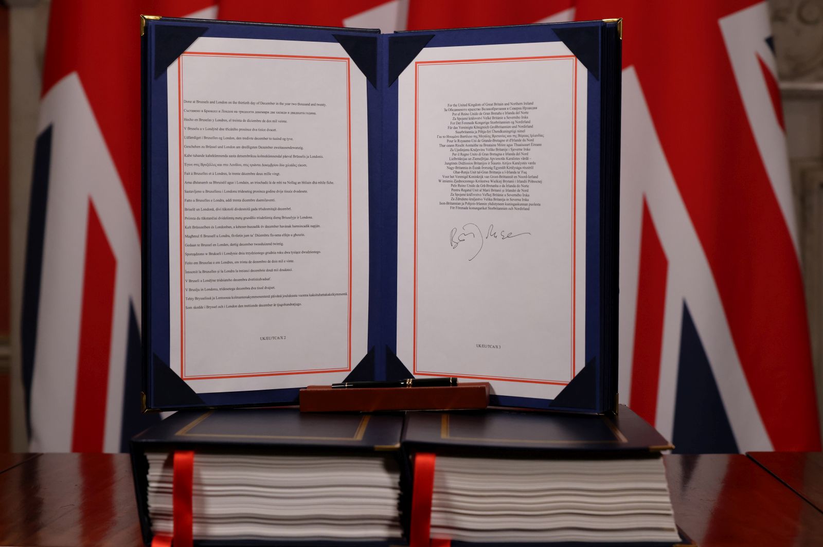 epa08912242 A handout photo made available by n10 Downing Street shows the Trade and Cooperation Agreement between the UK and the EU, the Brexit trade deal, signed by Britain's Prime Minister Boris Johnson, at 10 Downing Street London, Britain, 30 December 2020 (issued 31 December 2020).  EPA/ANDREW PARSONS/DOWNING STREET HANDOUT -- The Image can not be altered in any form. -- HANDOUT EDITORIAL USE ONLY/NO SALES