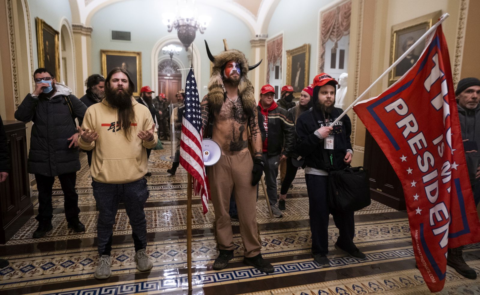 epa08923457 Supporters of US President Donald J. Trump stand by the door to the Senate chambers after they breached the US Capitol security in Washington, DC, USA, 06 January 2021. Protesters stormed the US Capitol where the Electoral College vote certification for President-elect Joe Biden took place.  EPA/JIM LO SCALZO