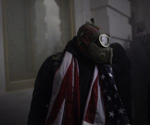 epa08923668 A person wears a gas mask as Pro-Trump protesters storm the grounds of the US Capitol, in Washington, DC, USA, 06 January 2021. Various groups of Trump supporters have broken into the US Capitol and rioted as Congress prepares to meet and certify the results of the 2020 US Presidential election.  EPA/WILL OLIVER