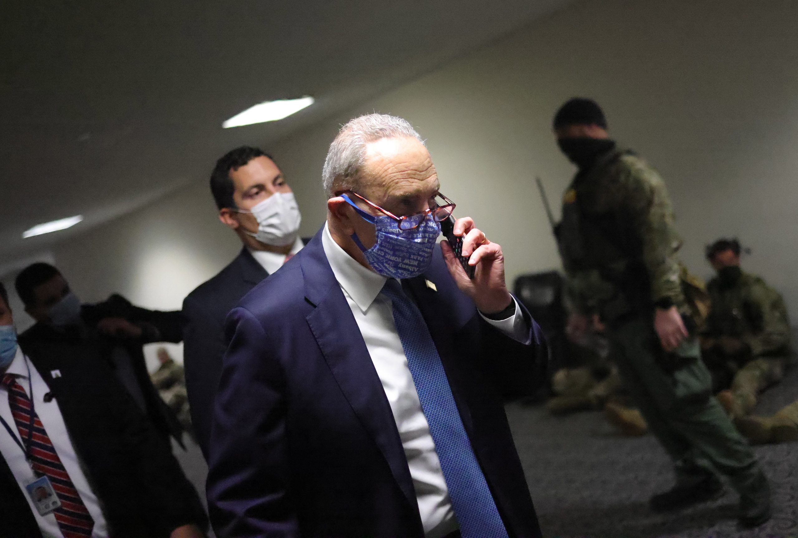 epa08923779 Senate Minority Leader Chuck Schumer (D-NY) walks to a room on Capitol Hill, in Washington, DC, USA, 06 January 2021. Various groups of Trump supporters have broken into the US Capitol and rioted as Congress prepares to meet and certify the results of the 2020 US Presidential election.  EPA/Win McNamee / POOL