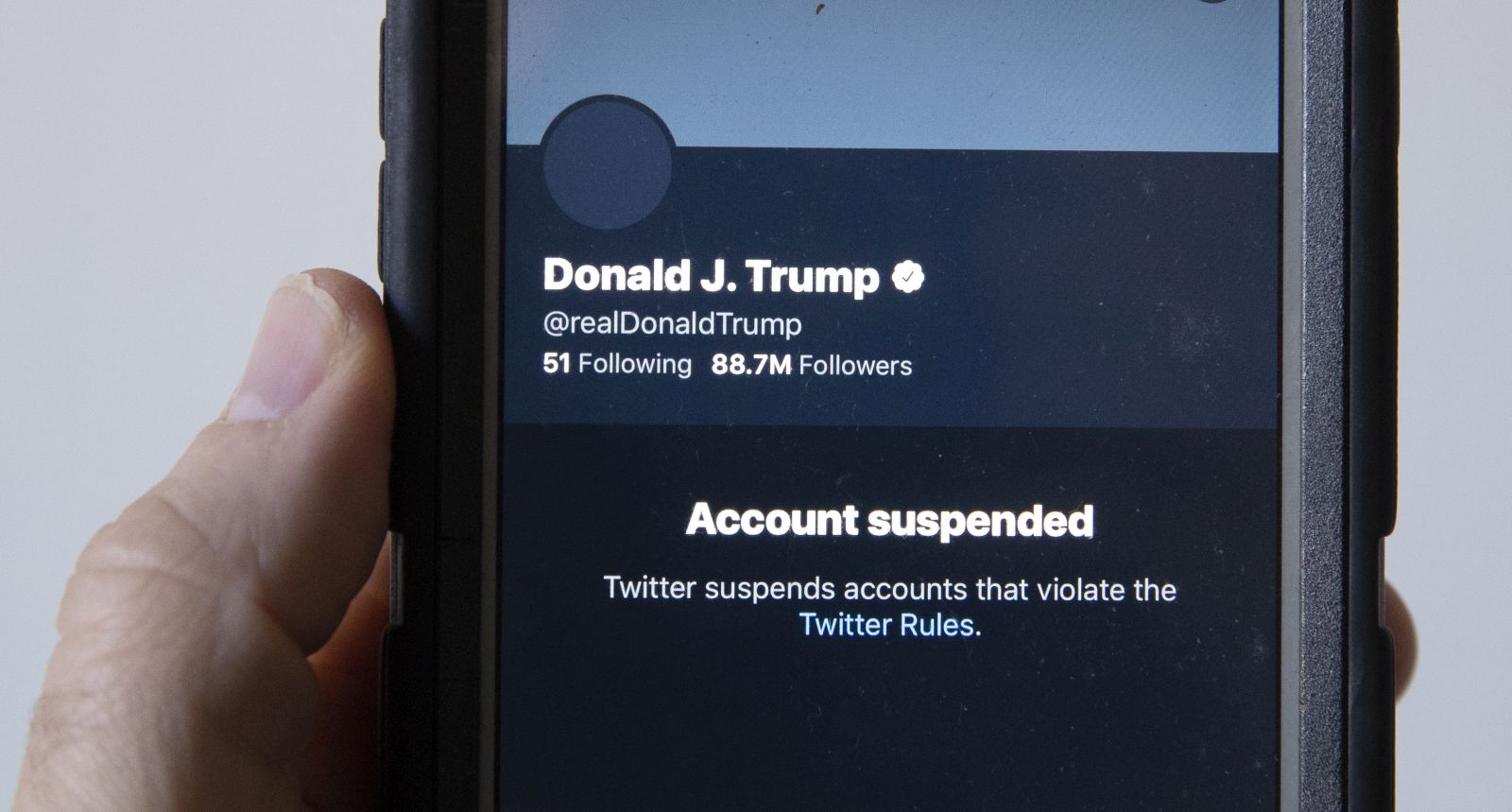 epa08928326 A mobile phone displays the suspended status of the Twitter account of US President Donald J. Trump, in Washington, DC, USA, 09 January 2021. Twitter made the decision to ban the account after Trump incited a mob of his supporters to riot on the US Capitol in an attempt to stop Congress from counting the electoral college votes, causing  chaos and several fatalities. Twitter issued a statement saying the company 'permanently suspended the account due to the risk of further incitement of violence'.  EPA/MICHAEL REYNOLDS