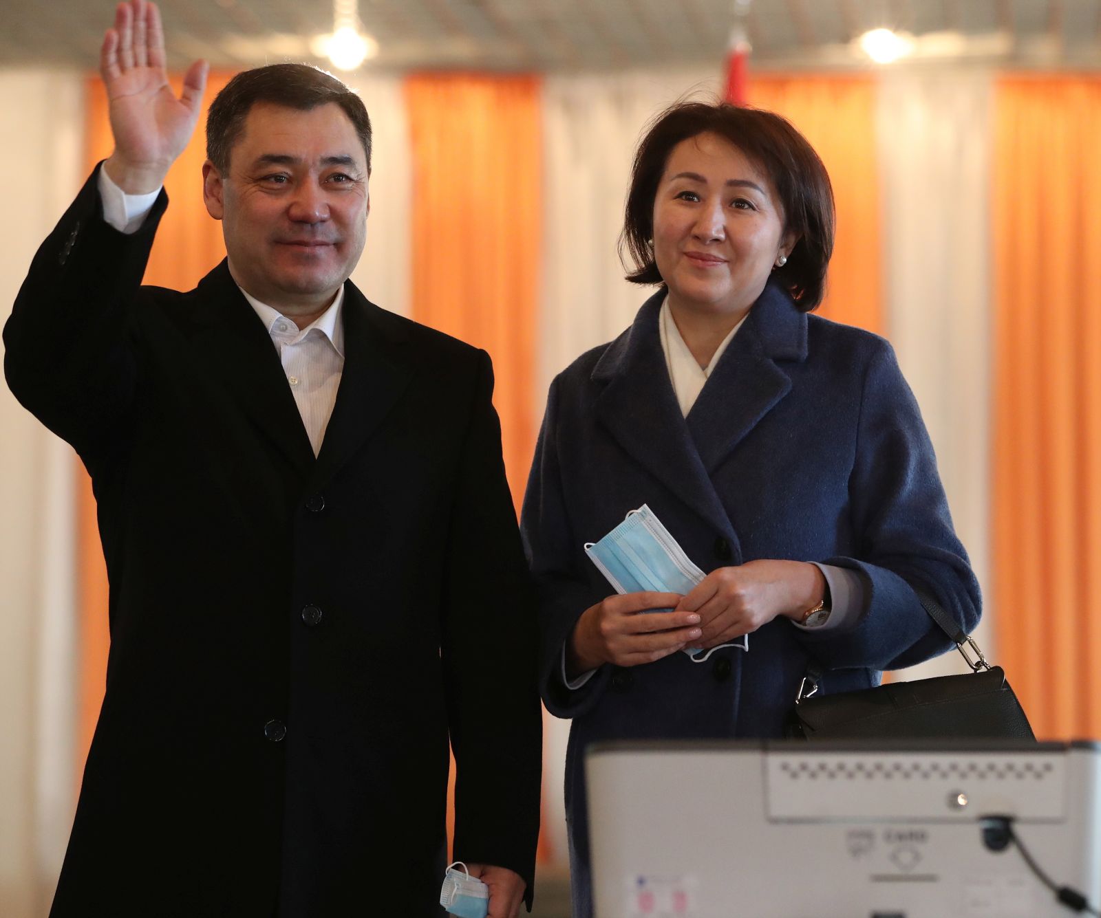 epa08929618 Presidential candidate Sadyr Japarov (L) reacts after casting his ballot during the presidential elections in Bishkek, Kyrgyzstan, 10 January 2021.Kyrgyzstan holds its presidential elections and a referendum on the form of government.  EPA/IGOR KOVALENKO