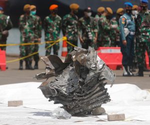 epa08930859 Indonesian soldiers look at a piece of the wrecked engine of Sriwijaya Air flight SJ182, found in the waters off Jakarta, at Tanjung Priok port in Jakarta, Indonesia, 11 January 2021. Sriwijaya Air flight SJ182, with 62 people on board, crashed in to water shortly after take off from Soekarno-Hatta International Airport while en route to Pontianak in West Kalimantan province, on 09 January 2021.  EPA/ADI WEDA