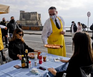 epa08931494 Preparations and first customers at the reopening of the restaurants on the Caracciolo seafront in Naples, Italy, 11 January 2021. Most of Italy went back to being a Yellow Zone on 11 January. In yellow zones, shops are allowed to open and restaurants and bars can serve customers until 6 p.m., after which time they can only do takeaway and delivery services.  EPA/CIRO FUSCO