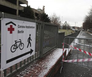 epa08936760 A sign reading 'Corona Vaccine Centre Berlin' is seen at an entrance of a Covid-19 vaccination centre at the Erika Hess Ice Stadium in Berlin, Germany, 14 January 2021. Berlin's new vaccination centre opens its door.  EPA/HAYOUNG JEON