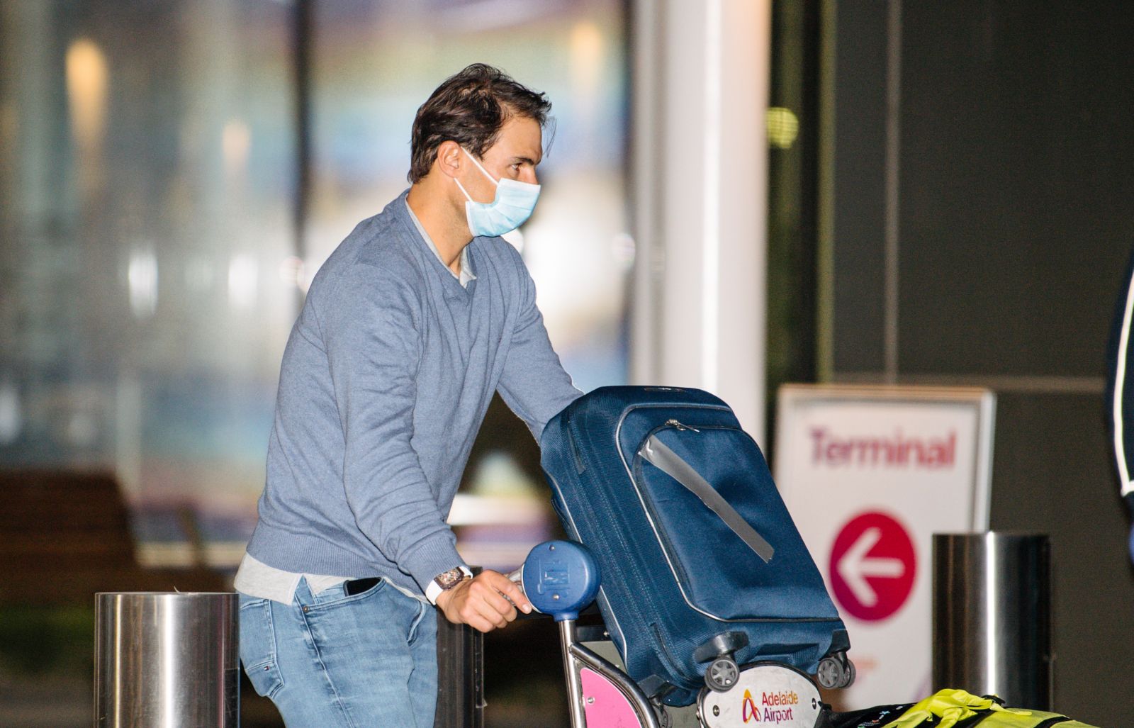 epa08936923 Rafael Nadal arrives at Adelaide Airport ahead of the Australian Open tennis tournament, Adelaide, Australia, 14 January 2021. Arriving players will serve a 14-day quarantine period ahead of the scheduled major set to get underway on 08 February.  EPA/MORGAN SETTE NO ARCHIVING AUSTRALIA AND NEW ZEALAND OUT