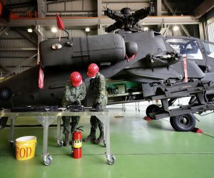 epa08938304 Taiwanese Air Force Aircraft mechanics work under AH-64 Apache attack helicopter during a visit by Taiwan's President Tsai Ing-wen (not pictured) at a military base in Taiwan, 15 January 2021. US Under Secretary of State Keith Krach said on 14 January that the recent lifting of restrictions on contacts between American and Taiwanese officials by the US government gives Taiwan a 'free country status', referring to an announcement made on 09 January by US Secretary of State Mike Pompeo.  EPA/RITCHIE B. TONGO
