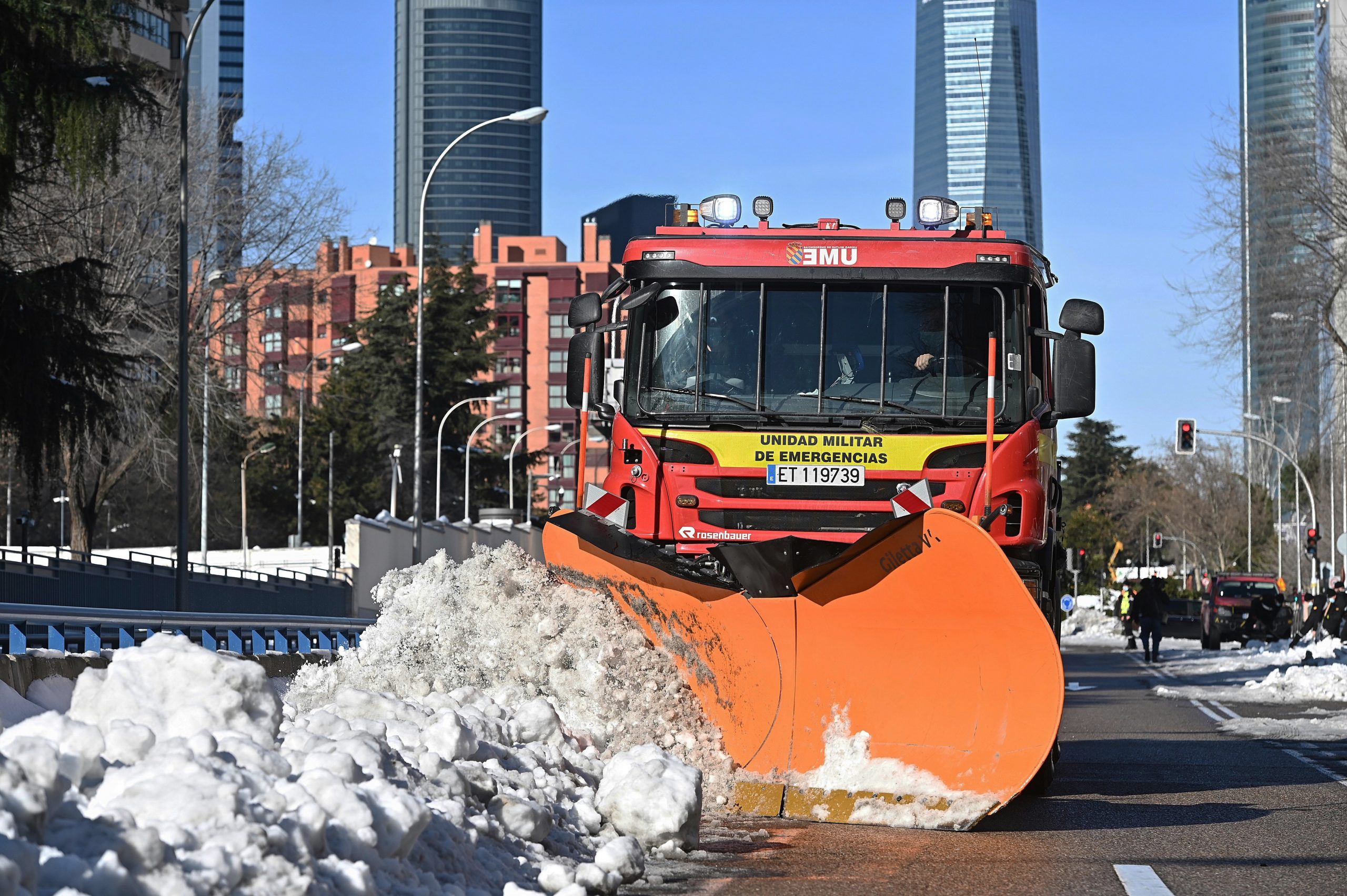 epa08938806 A snowplough from Spain's Military Emergency Unit (UME) cleans a street in downtown Madrid after the heavy snowfall caused by the storm Filomena, during the visit of the Minister of Defense, Margarita Robles (not pictured) to the area, in Madrid, Spain, 15 January 2021.  EPA/FERNANDO VILLAR