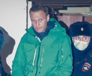 epa08946490 Russian opposition leader and anti-corruption activist Alexei Navalny (C) is escorted out of a police station in Khimki outside Moscow, Russia 18 January 2021. A Moscow judge on 18 January ruled that Navalny remains in custody for 30 days after his airport arrest on 17 January 2020 after his arrival from Germany.  EPA/SERGEI ILNITSKY