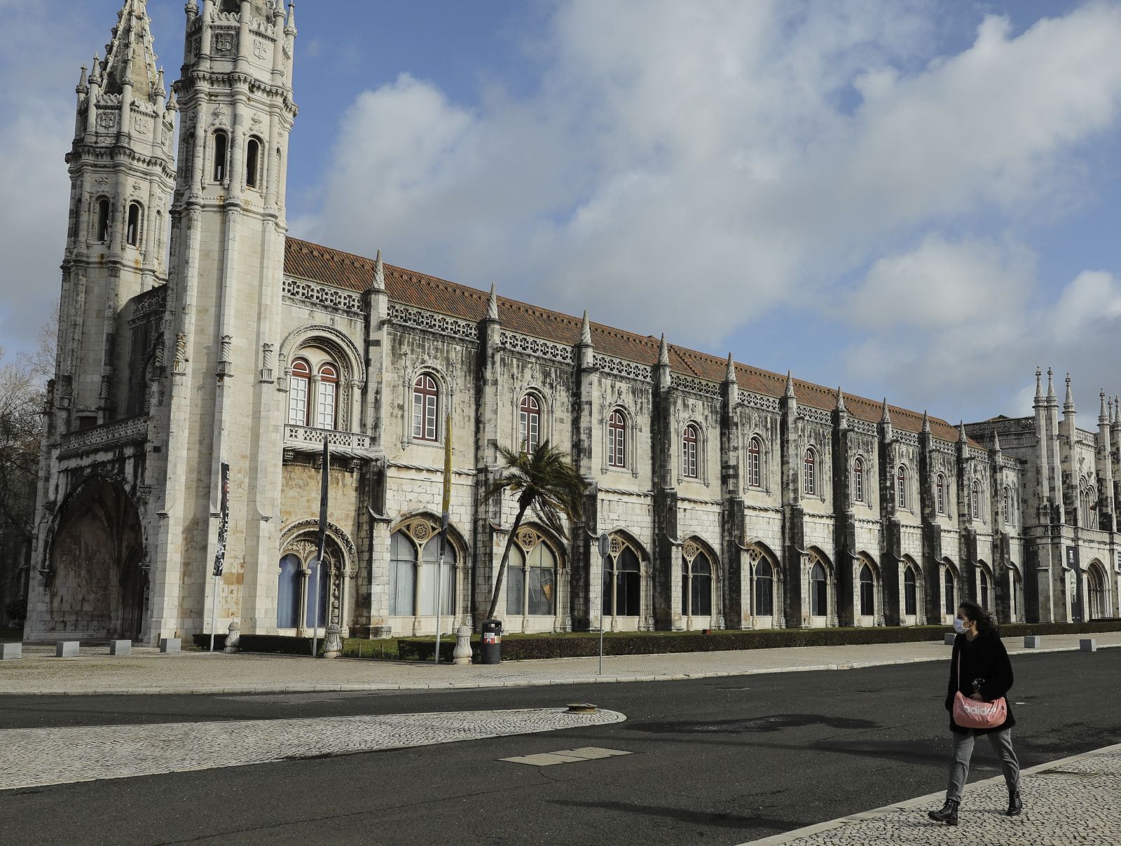 epa08957560 A pedestrian walks near Jeronimos Monastery in Lisbon, Portugal, 22 January 2021. All schools at all levels of education are closed as of 22 January for two weeks, a measure announced on 21 January by the government to contain the COVID-19 pandemic.  EPA/MIGUEL A. LOPES