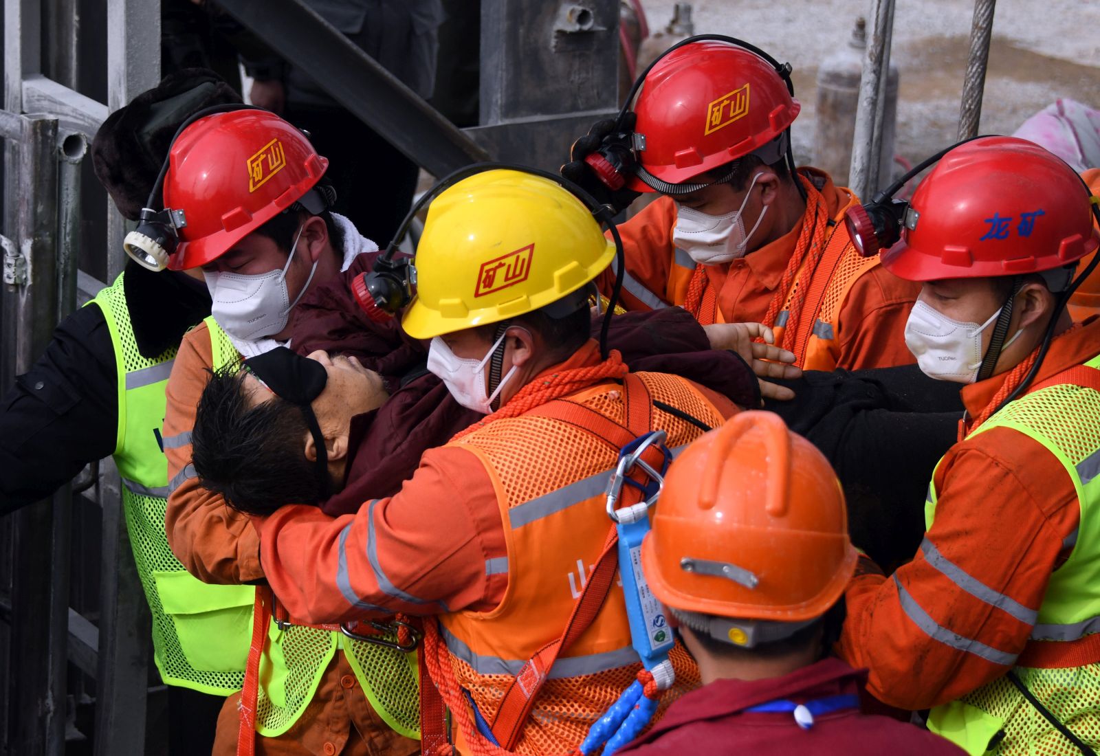 epa08961562 A picture released by Xinhua News Agency shows a trapped miner being lifted from a gold mine in Qixia City, east China's Shandong Province, 24 January 2021. The miner, who has been trapped underground for two weeks after a blast in a gold mine, was found by rescuers on 24 January morning that who is in extremely weak condition, was lifted from the mine at 11:13 a.m. on 24 January 2021. As many as twenty-two miners have been trapped about 600 meters underground since the mine blast on 10 January 2021 in Qixia, east China's Shandong Province.  EPA/CHEN HAO/XINHUA -- MANDATORY CREDIT: XINHUA --  EDITORIAL USE ONLY/NO SALES
