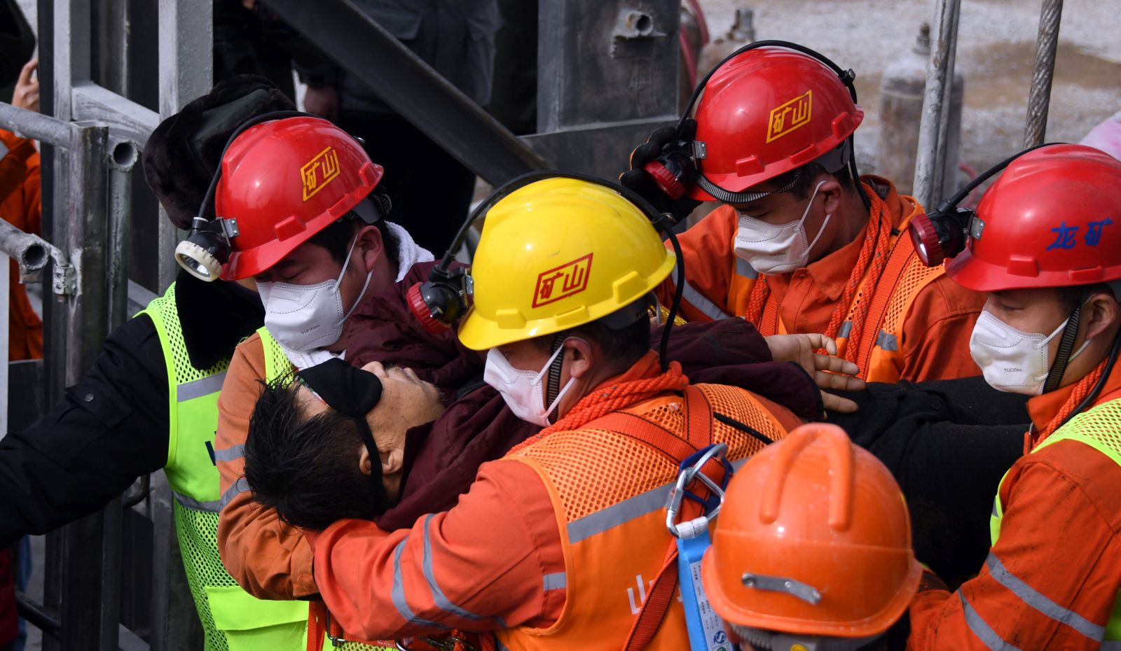 epa08961562 A picture released by Xinhua News Agency shows a trapped miner being lifted from a gold mine in Qixia City, east China's Shandong Province, 24 January 2021. The miner, who has been trapped underground for two weeks after a blast in a gold mine, was found by rescuers on 24 January morning that who is in extremely weak condition, was lifted from the mine at 11:13 a.m. on 24 January 2021. As many as twenty-two miners have been trapped about 600 meters underground since the mine blast on 10 January 2021 in Qixia, east China's Shandong Province.  EPA/CHEN HAO/XINHUA -- MANDATORY CREDIT: XINHUA --  EDITORIAL USE ONLY/NO SALES