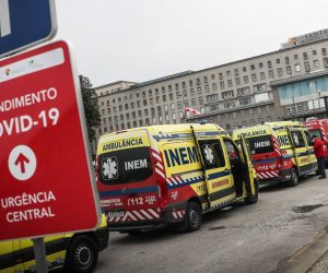 epa08971548 Dozens of ambulances with patients wait outside Santa Maria Hospital in Lisbon to leave the patients in the hospital emergency room, Lisbon, Portugal, 28 January 2021. The Centro Hospitalar Lisboa Norte (CHLN) reports that this emergency service of the Santa Maria Hospital 'has registered peaks of affluence', that 'almost half of the users are transported by ambulance.'  EPA/MARIO CRUZ