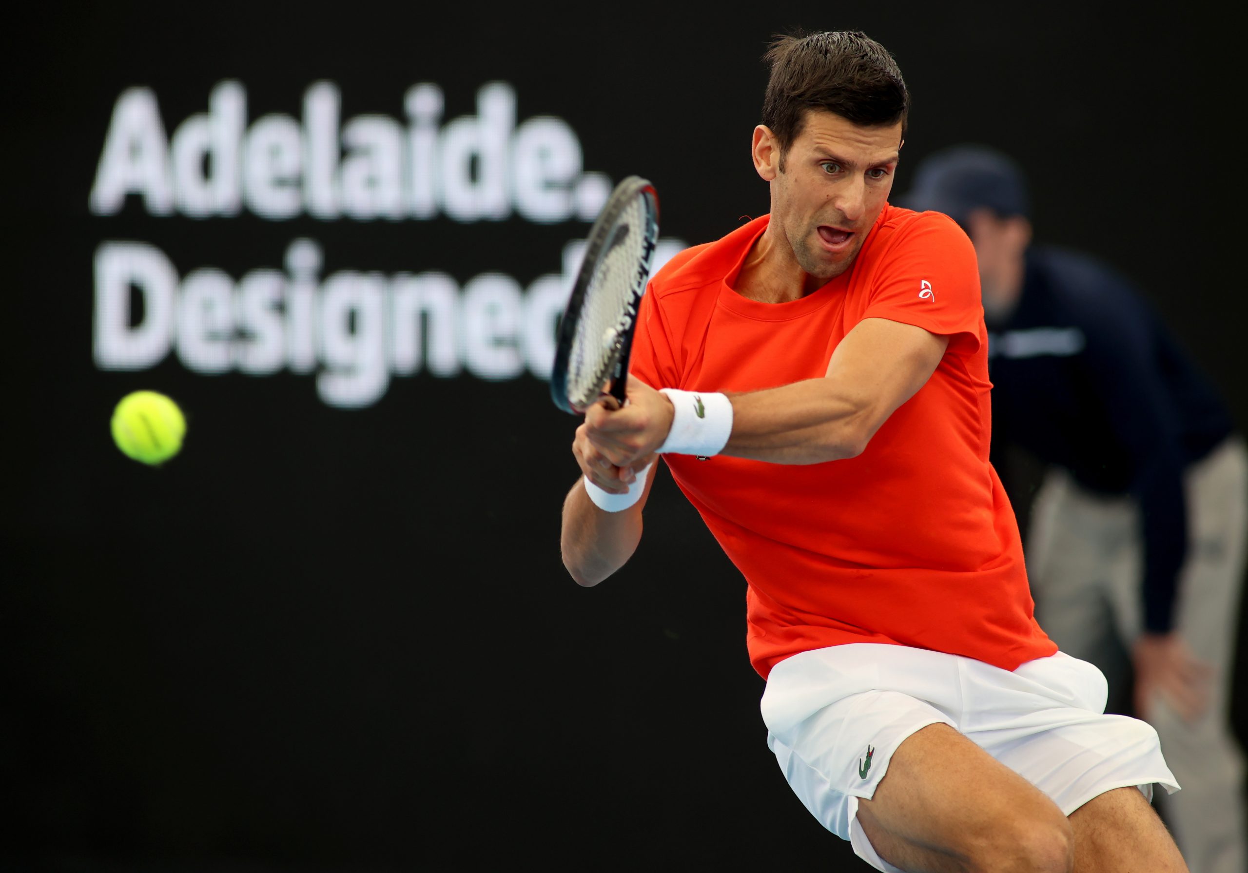 epa08972277 Novak Djokovic of Serbia plays a backhand against Jannik Sinner of Italy during their match at the 'A Day at the Drive' tennis event at Memorial Drive Tennis Centre in Adelaide, Australia, 29 January 2021.  EPA/KELLY BARNES AUSTRALIA AND NEW ZEALAND OUT