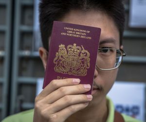 epa08972446 (FILE) An activist holds a British passport during a rally in support of Simon Cheng, a staff member of the consulate, outside the British Consulate General office, in Hong Kong, China, 21 August 2019. Beijing will not recognise British National (Overseas) passports as travel documents from Sunday, 31 January 2021.  EPA/ROMAN PILIPEY *** Local Caption *** 55407127