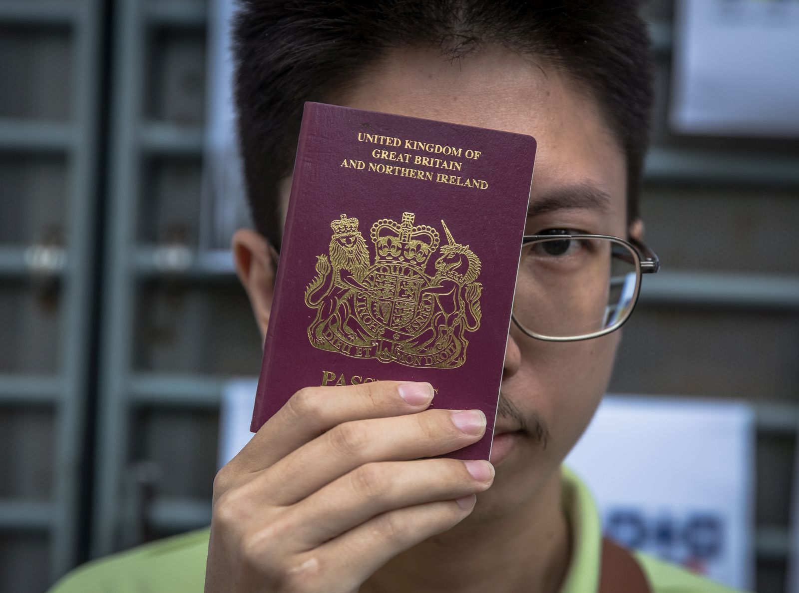 epa08972446 (FILE) An activist holds a British passport during a rally in support of Simon Cheng, a staff member of the consulate, outside the British Consulate General office, in Hong Kong, China, 21 August 2019. Beijing will not recognise British National (Overseas) passports as travel documents from Sunday, 31 January 2021.  EPA/ROMAN PILIPEY *** Local Caption *** 55407127