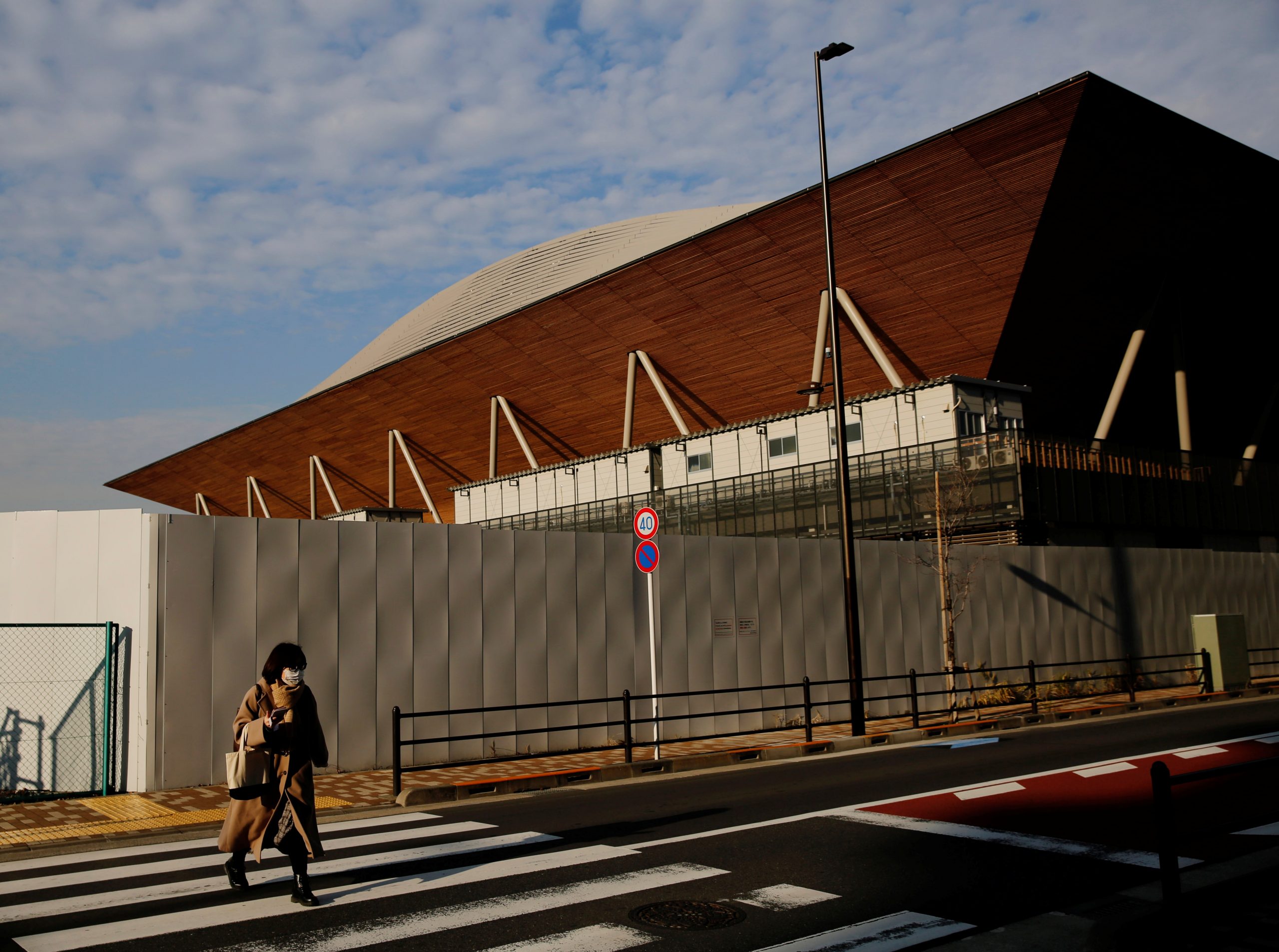 Ariake Gymnastics Centre for the Tokyo 2020 Olympic Games, amid the coronavirus disease (COVID-19) outbreak, in Tokyo A woman wearing a protective mask walks past Ariake Gymnastics Centre for the Tokyo 2020 Olympic Games, amid the coronavirus disease (COVID-19) outbreak, in Tokyo, Japan, January 22, 2021. REUTERS/Kim Kyung-Hoon KIM KYUNG-HOON