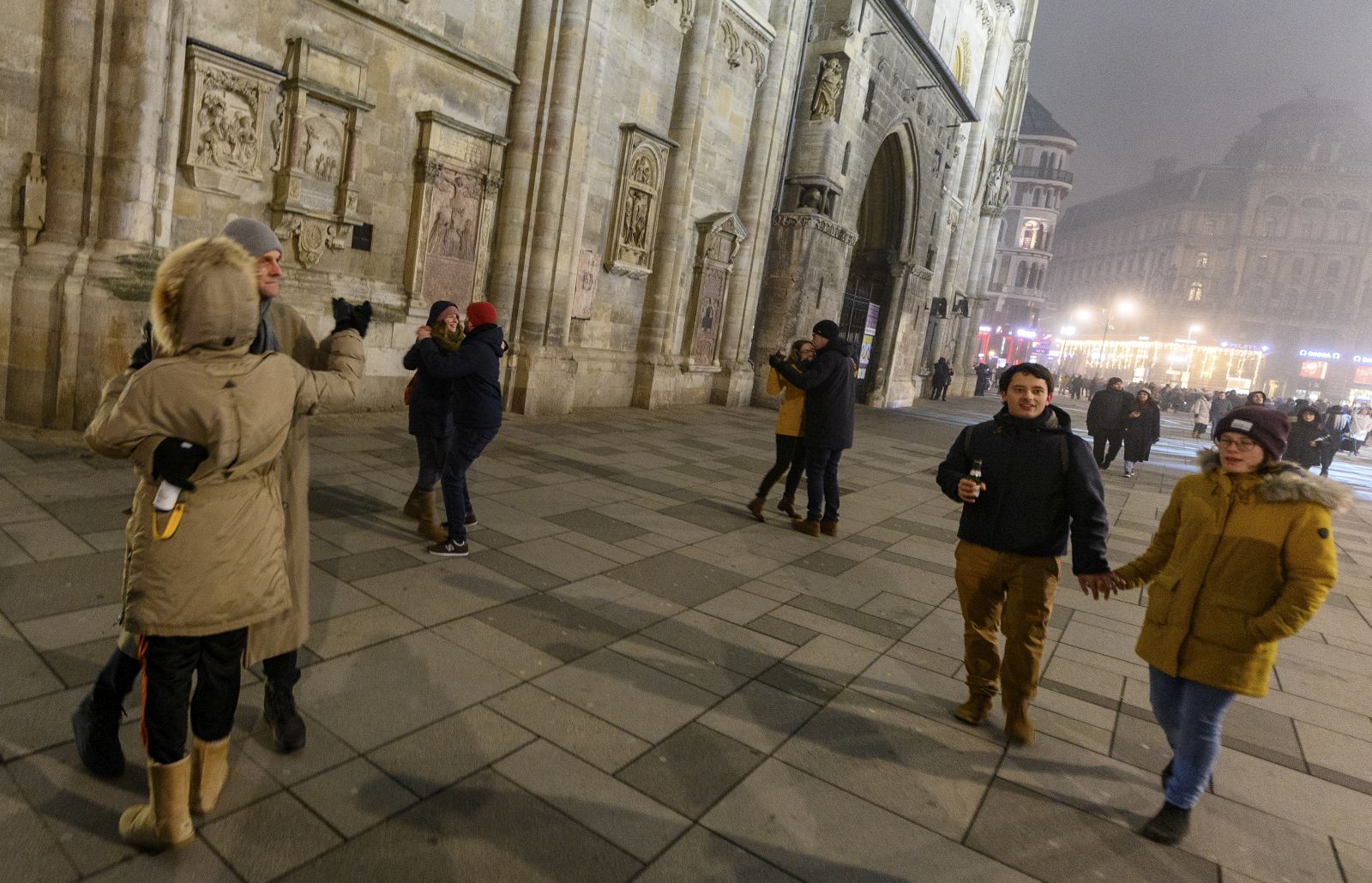 epaselect epa08913438 People dance a walz as they celebrate the New Year’s Eve at the Stephansplatz square in front of the Saint Stephen's Cathedral during a nationwide COVID-19 lockdown in Vienna, Austria, 01 January 2021.  EPA/CHRISTIAN BRUNA
