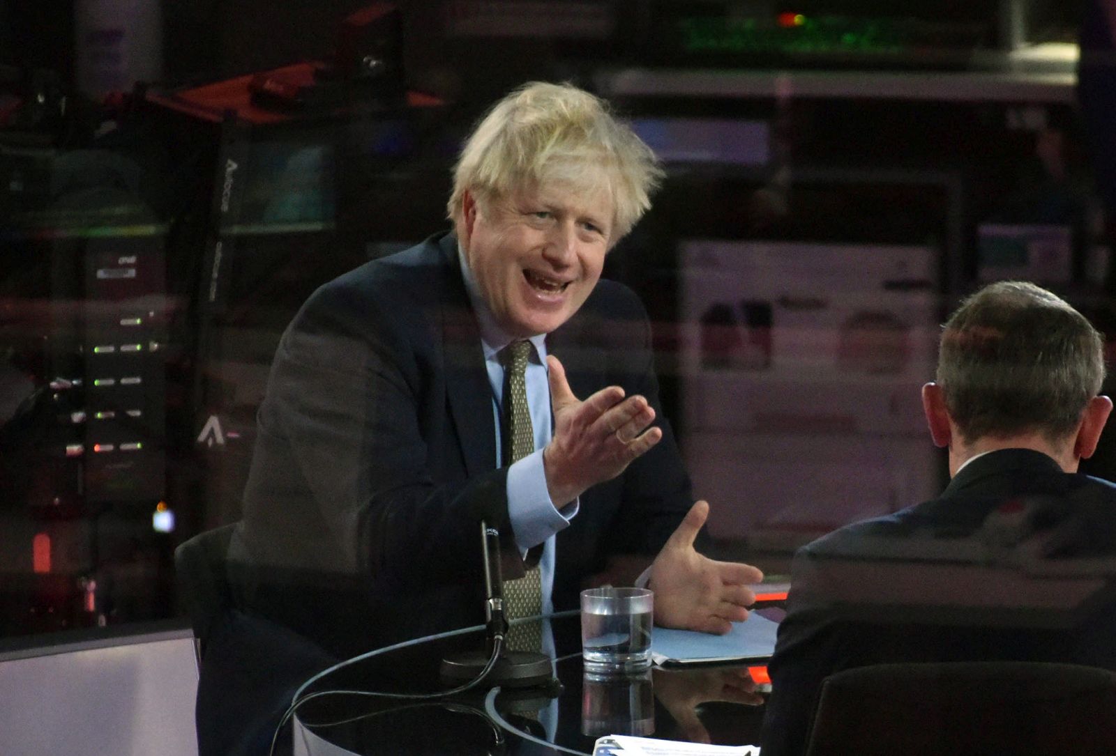 epa08916421 A handout photo made available by the British Broadcasting Corporation (BBC) shows Britain's Prime Minister Boris Johnson appearing at the Andrew Marr show in the BBC studios in London, Britain, 03 January 2021. Johnson said during the interview that Boris Johnson told the BBC that Britain may be facing tougher measures in weeks ahead as the nation battles the ongoing COVID-19 coronavirus pandemic.  EPA/JEFF OVERS HANDOUT ATTENTION EDITORS: PICTURE TAKEN THROUGH GLASS HANDOUT EDITORIAL USE ONLY/NO SALES