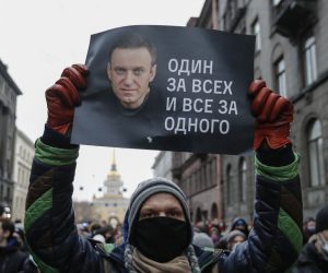 epa08959951 A protester holds a poster that reads 'One for all and all for one', during an unauthorized protest in support of Russian opposition leader and blogger Alexei Navalny, in St. Petersburg, Russia, 23 January 2021. Navalny was detained after his arrival to Moscow from Germany on 17 January 2021. A Moscow judge on 18 January ruled that he will remain in custody for 30 days following his airport arrest. Navalny urged Russians to take to the streets to protest. In many Russian cities mass events are prohibited due to an increasing number of cases of the COVID-19 pandemic caused by the SARS CoV-2 coronavirus.  EPA/ANATOLY MALTSEV