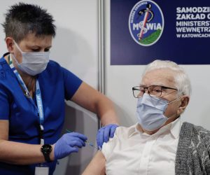 epa08963598 Wlodzimierz Czechowski (R) is the first senior in Poland to be vaccinated against the COVID-19, in a temporary hospital at the International Congress Center in Katowice, Poland, 25 January 2021. Vaccination for seniors against the coronavirus disease (COVID-19) has started across the country.  EPA/ANDRZEJ GRYGIEL POLAND OUT