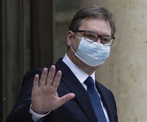 epa08979630 French President Emmanuel Macron wearing a protective face mask (R) greets Serbian President Aleksandar Vucic (L) as he arrives for a meeting and lunch at the Elysee Palace in Paris, France, 01 February 2021.  EPA/IAN LANGSDON