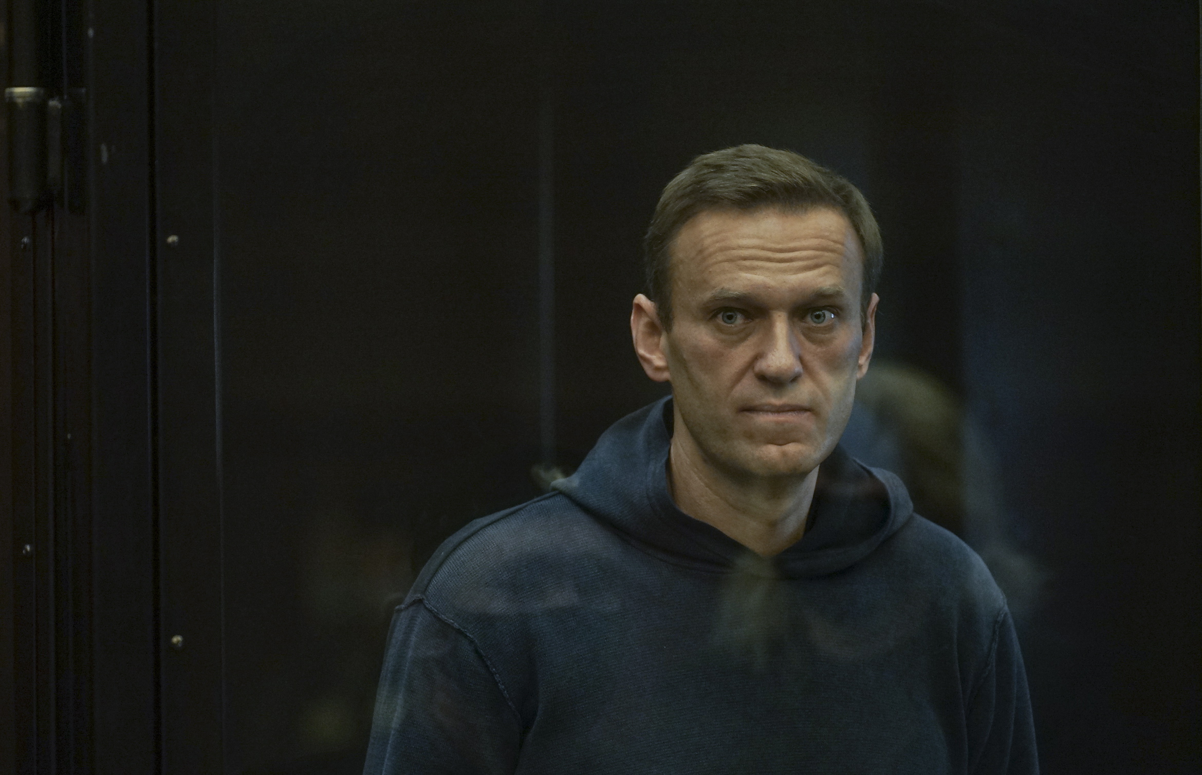 epa08980966 A handout photo made available by Moscow's Citiy Court Press Service shows Russian opposition leader Alexei Navalny (L) standing in the glass cage during a hearing in the Moscow City Court in Moscow, Russia, 02 February 2021. The Moscow City Court will consider on 02 February 2021 the requirement of the Federal Penitentiary Service to replace Alexei Navalny's suspended sentence with a real one. Opposition leader Alexei Navalny was detained after his arrival to Moscow from Germany on 17 January 2021. A Moscow judge on 18 January ruled that he will remain in custody for 30 days following his airport arrest.  EPA/MOSCOW CITY COURT PRESS SERVICE HANDOUT MANDATORY CREDIT HANDOUT EDITORIAL USE ONLY/NO SALES  EPA-EFE/MOSCOW CITY COURT PRESS SERVICE HANDOUT MANDATORY CREDIT HANDOUT EDITORIAL USE ONLY/NO SALES