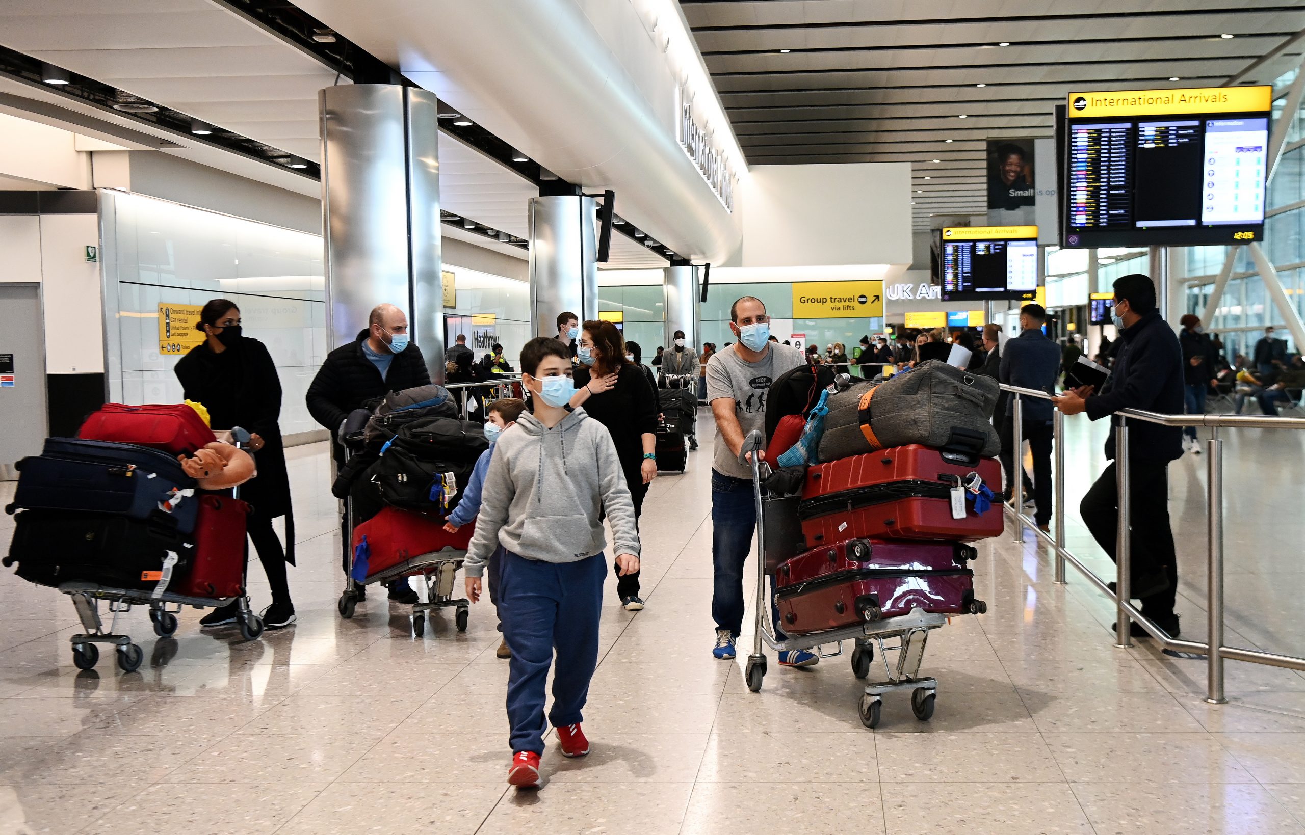 epa08989067 Travellers arrive at Heathrow Airport in London, Britain, 05 February 2021. The UK government is set to implement stricter measures for travellers arriving at Heathrow from Monday 15 February 2021. People arriving into Heathrow from so called 'at risk' countries will have to isolate in designated government hotels for up to ten days at their own cost.  EPA/ANDY RAIN