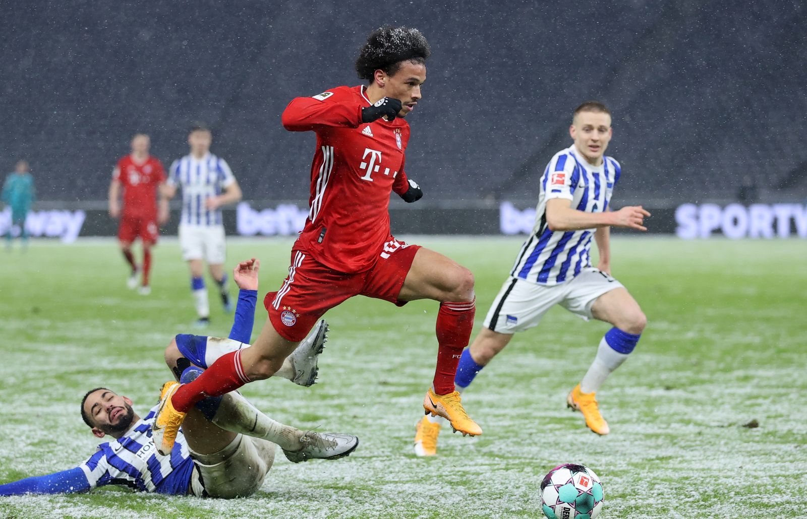 epa08990103 Matheus Cunha (L) of Berlin challenges Leroy Sane of Muenchen during the German Bundesliga soccer match between Hertha BSC and FC Bayern Munich at Olympiastadion in Berlin, Germany, 05 February 2021.  EPA/Boris Streubel / POOL DFL regulations prohibit any use of photographs as image sequences and/or quasi-video.