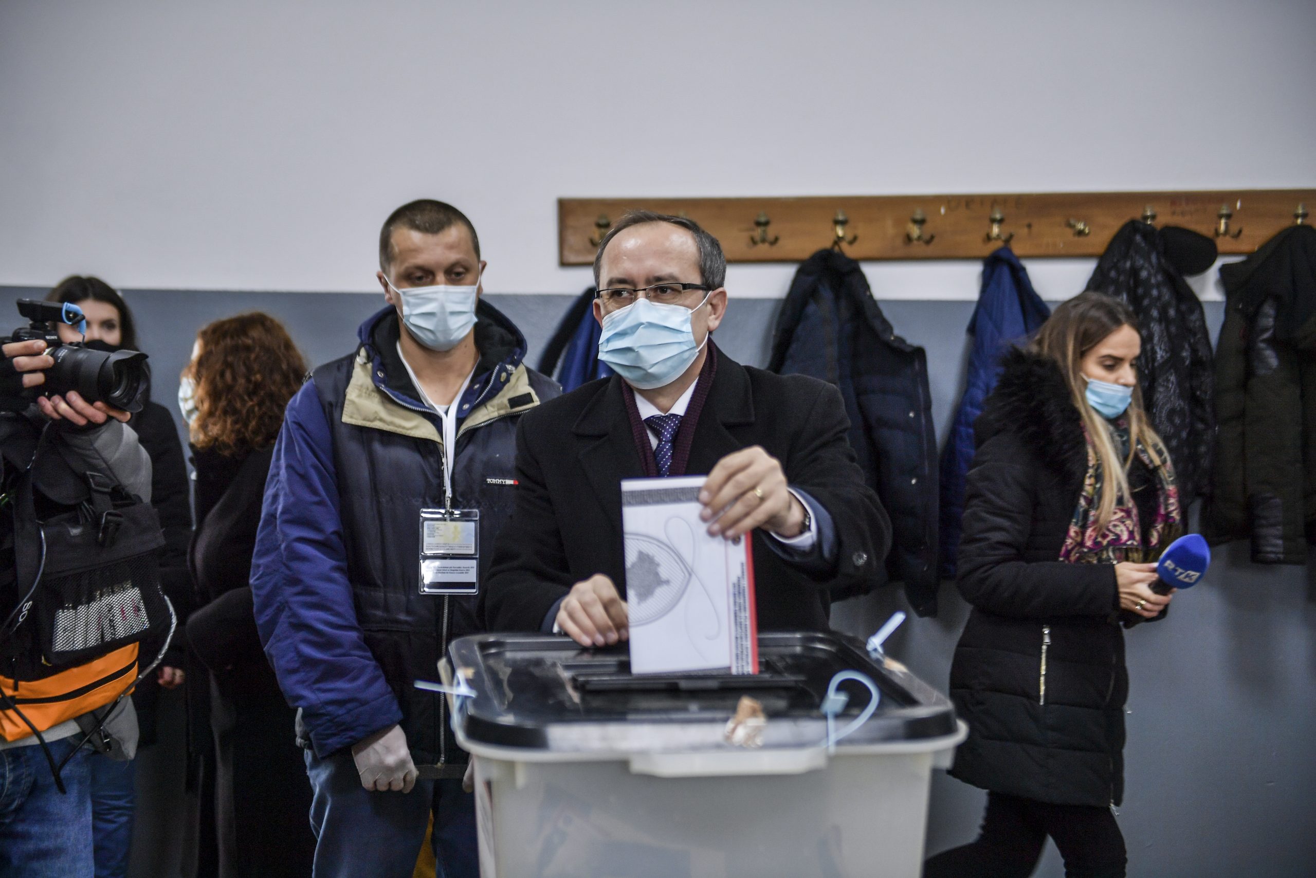 epa09011507 A handout photo made available by the Government of Kosovo shows Acting Prime Minister of Kosovo Avdullah Hoti (C) casting his vote at a voting center in Pristina, Kosovo, 14 February 2021. Kosovo's early parliamentary elections will be held on 14 February 2021. Around 1.8 million voters have the right to cast ballots during snap elections to elect a new 120 seat parliament.  EPA/ERMAL META/KOSOVO GOVERNMENT HANDOUT  HANDOUT EDITORIAL USE ONLY/NO SALES