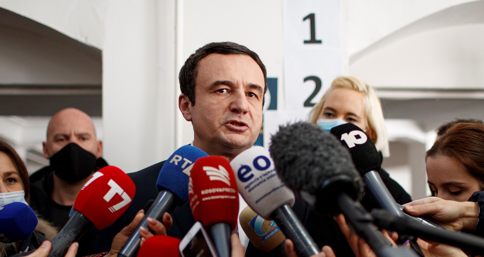 epa09011380 Leader of the movement Self-determination (Vetevendoje) Albin Kurti (C) talks to the media after he voted in the parliamentary elections, in Pristina, Kosovo, 14 February 2021. Kosovo's early parliamentary elections will be held on 14 February 2021. Around 1.8 million voters have the right to cast ballots during snap elections to elect a new 120 seat parliament.  EPA/VALDRIN XHEMAJ