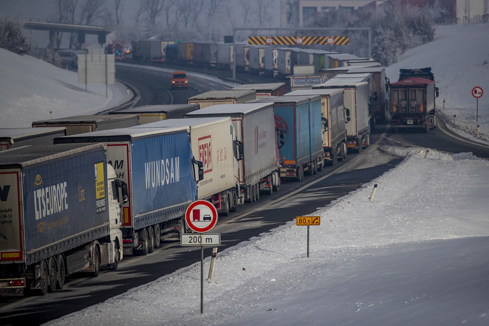epa09014005 Trucks stand in the about 30km-long-tailback on highway D8 in direction of German border near Usti nad Labem, Czech Republic, 15 February 2021. Germany reinstated temporary entry bans and border controls from Czech Republic due to growing numbers of coronavirus variant cases in the Czech country. Starting from 14 February, stricter entry rules apply to the German border with the Czech Republic and the Austrian state of Tyrol. On first working day tailbacks of trucks created in directions of German borders across the country.  EPA/MARTIN DIVISEK