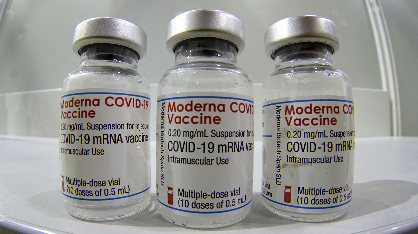 epa09017657 Three vials of the 'Moderna COVID-19 Vaccine' are pictured in a new coronavirus COVID-19 vaccination center at the 'Velodrom' stadium in Berlin, Germany, 17 February 2021.  EPA/MICHAEL SOHN / POOL