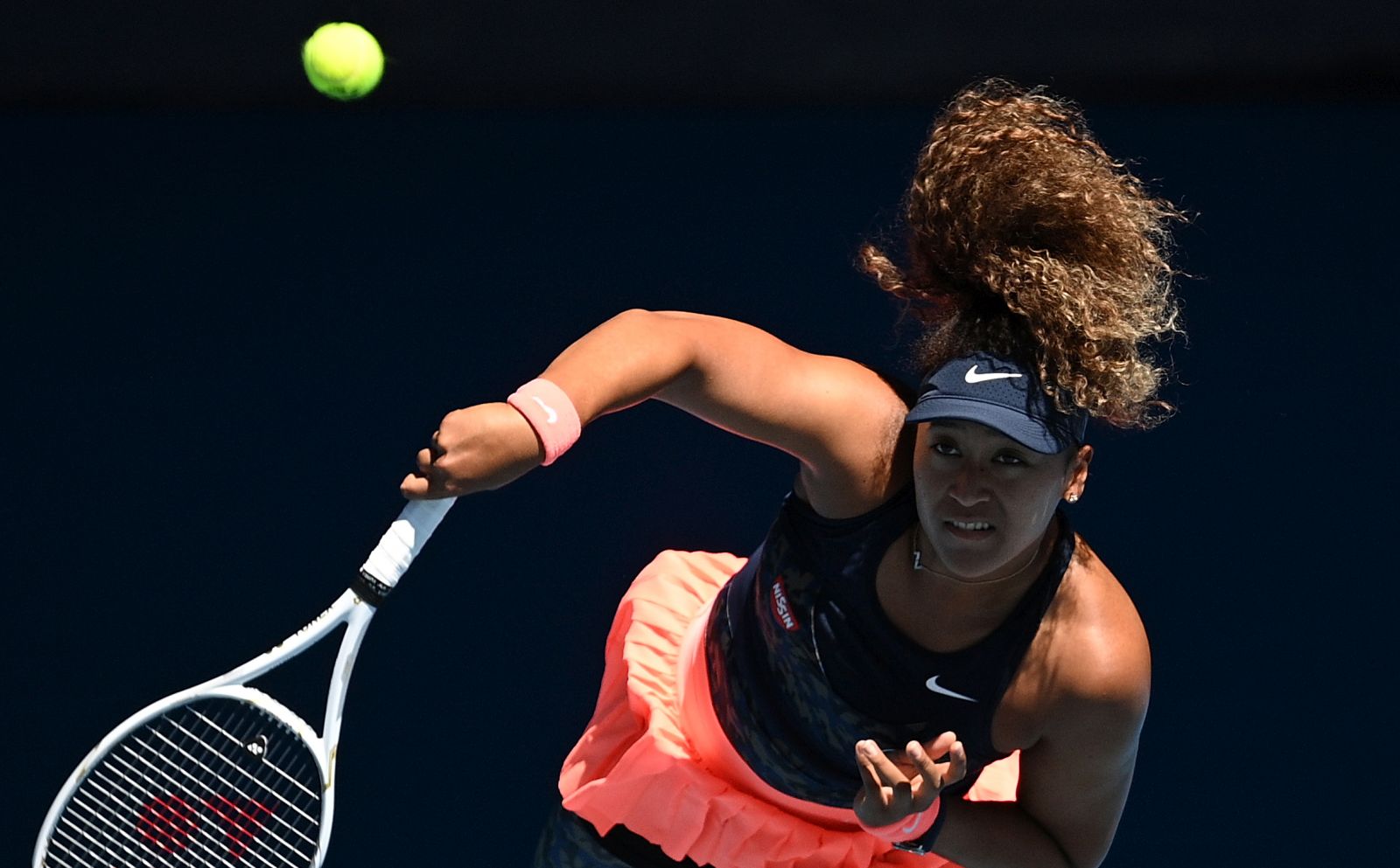 epa09020200 Naomi Osaka of Japan in action during her Women's singles semifinals match against Serena Williams of the United States on Day 11 of the Australian Open Grand Slam tennis tournament at Melbourne Park in Melbourne, Australia, 18 February 2021.  EPA/DEAN LEWINS AUSTRALIA AND NEW ZEALAND OUT