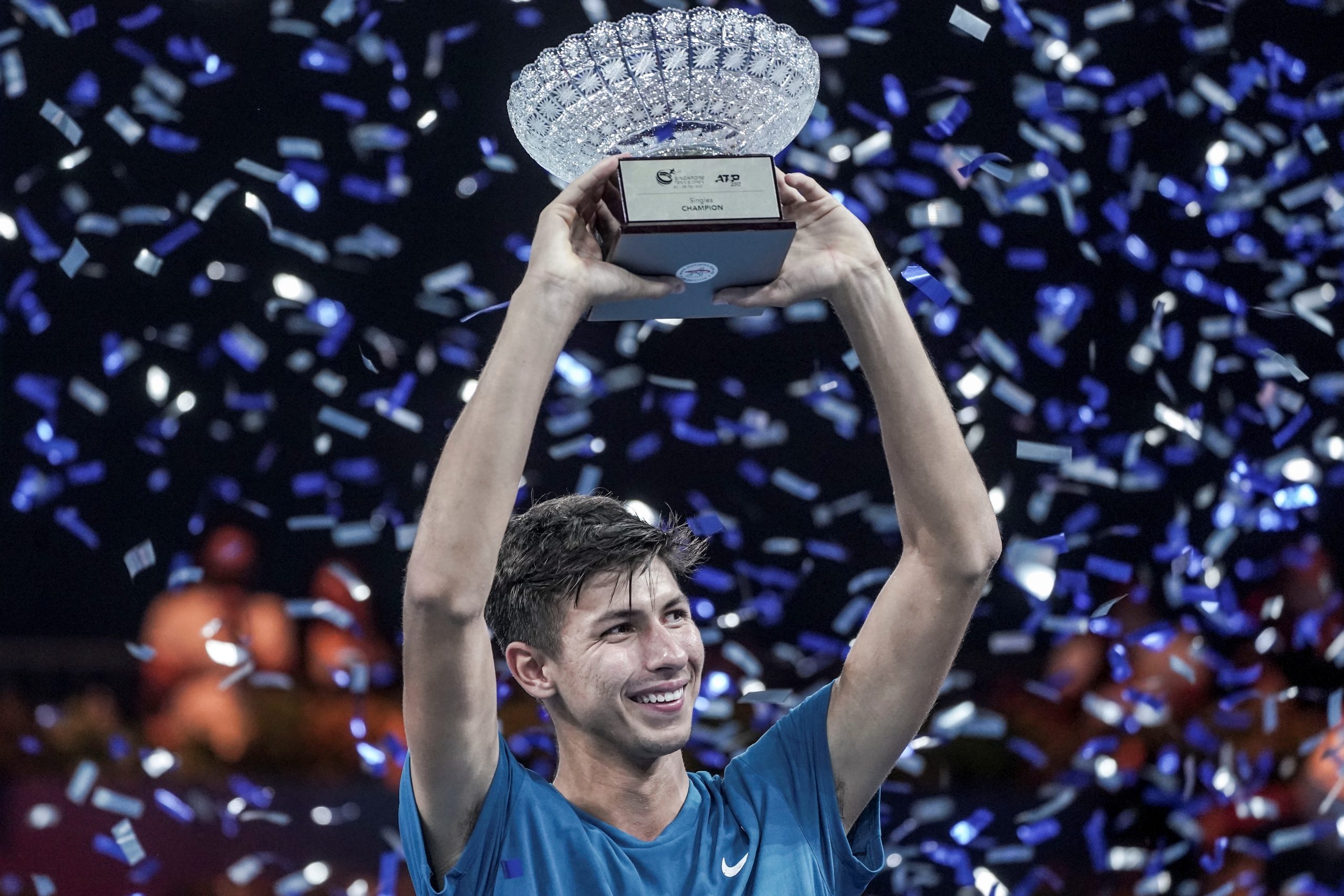 epa09042009 Alexei Popyrin of Australia holds up the trophy  after winning his men's singles final match against Alexander Bublik of Kazakhstan at the Singapore Tennis Open ATP 250 held at the OCBC Arena in Singapore, 28 February 2021.  EPA/WALLACE WOON
