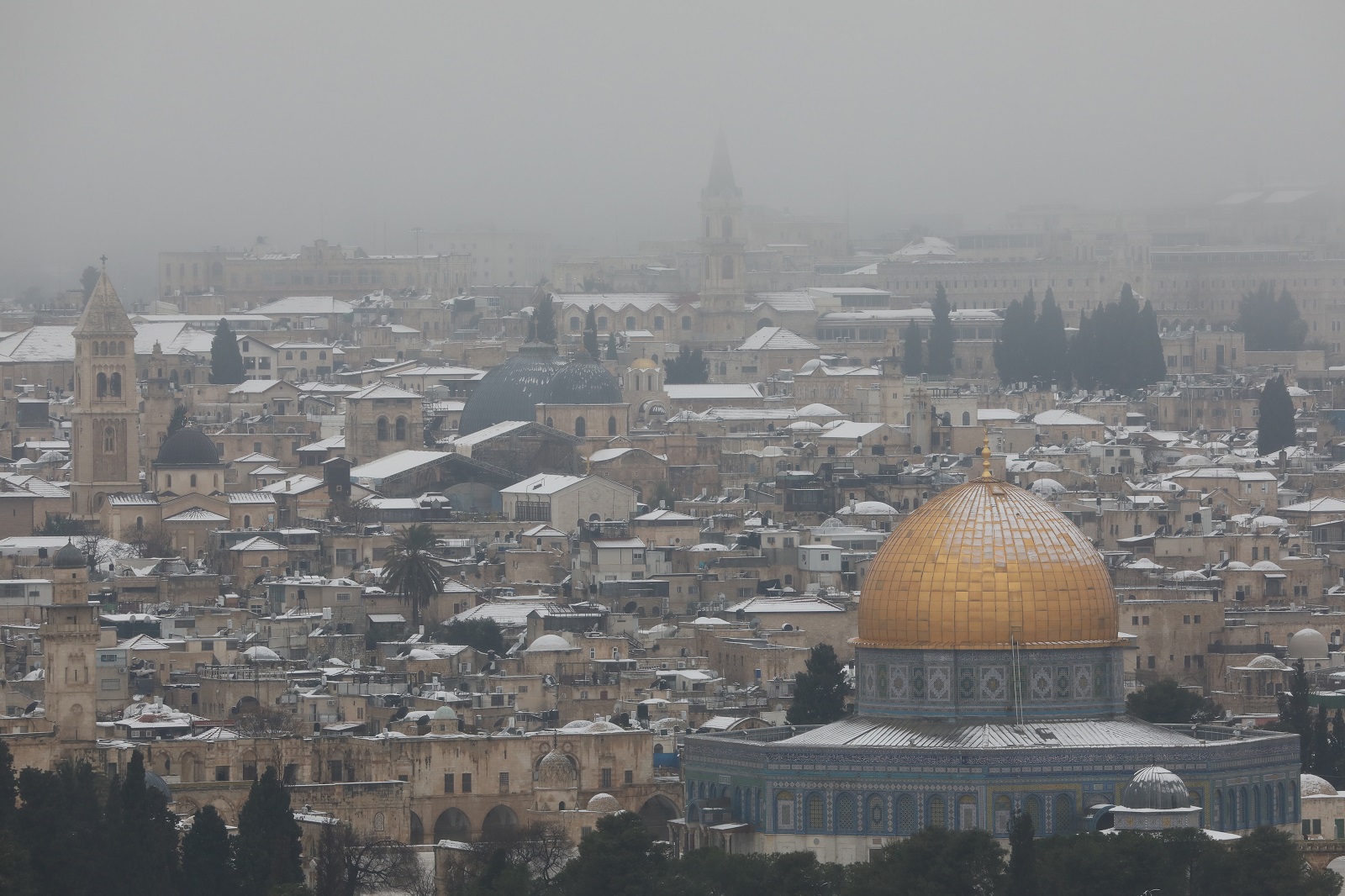 epa09020433 General view of the Dome of the Rock covered in snow, in the old city of Jerusalem, Israel, 18 February 2021.  EPA/ABIR SULTAN