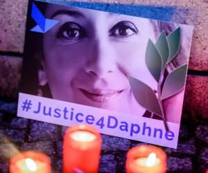 epa09031963 (FILE) - 'Justice four Daphne' is written on a cardboard showing a photo of Daphne Caruana Galizia, during a picket in front of the Maltese embassy for murdered journalist Daphne Caruana Galizia in Berlin, Germany, 16 October 2019 (reissued 23 February 2021). More than three years after the murder of journalist Daphne Caruana Galizia in Malta, a court has sentenced one of three defendants to 15 years in prison, after he admitted to the killing, media in Malta reported. Maltese journalist Daphne Caruana Galizia was killed on 16 October 2017 in Malta, while investigating the Panama Papers case.  EPA/CLEMENS BILAN *** Local Caption *** 55553937