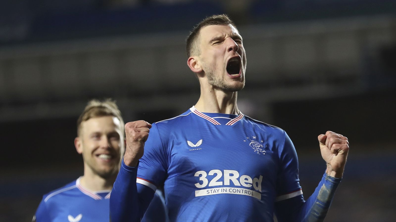 epa09036556 Borna Barisic of Rangers celebrates after scoring the 4-2 lead from the penalty spot during the UEFA Europa League round of 32, second leg soccer match between Glasgow Rangers and Royal Antwerp FC in London, Britain, 25 February 2021.  EPA/Ian McNicol / POOL