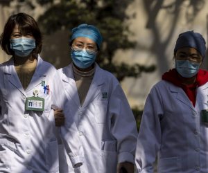 epa09045886 Medical workers walk on the street in Shanghai, China, 02 March 2021. According to the National Health Commission, the China mainland reported 19 imported cases of COVID-19 and no new locally transmitted cases on 01 March 2021.  EPA/ALEX PLAVEVSKI