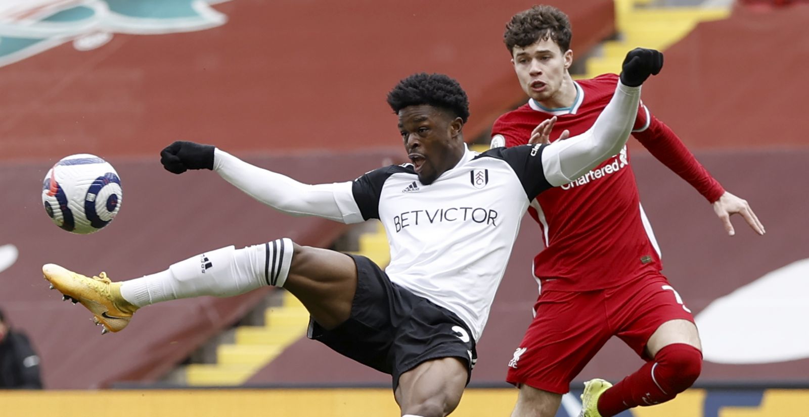 epa09059191 Josh Maja (L) of Fulham in action during the English Premier League soccer match between Liverpool FC and Fulham FC in Liverpool, Britain, 07 March 2021.  EPA/Phil Noble / POOL EDITORIAL USE ONLY. No use with unauthorized audio, video, data, fixture lists, club/league logos or 'live' services. Online in-match use limited to 120 images, no video emulation. No use in betting, games or single club/league/player publications.