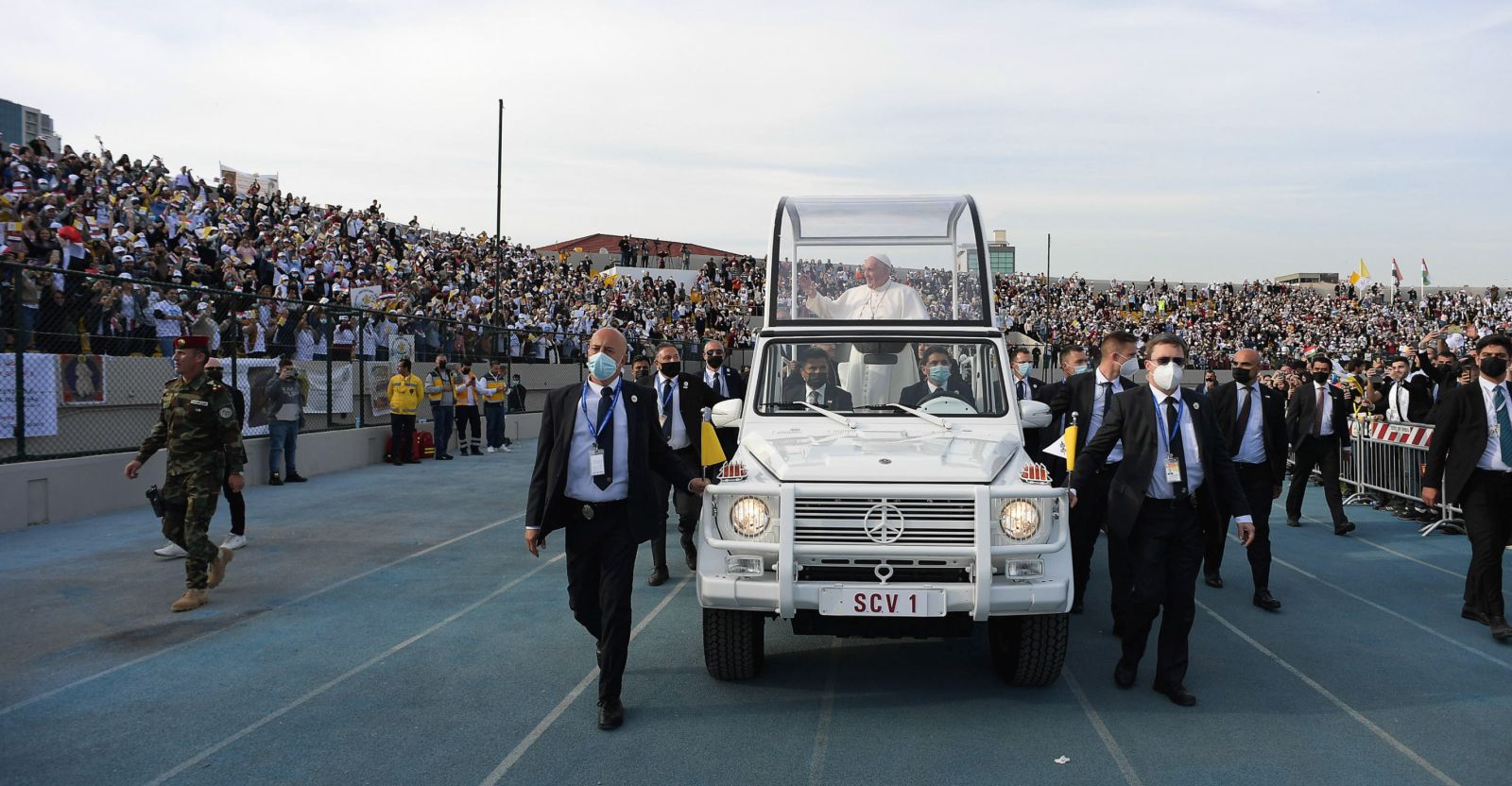 epa09059523 Pope Francis (C) ride the Papal Mobil as he arrives to celebrate the Holy Mass at the 'Franso Hariri' Stadium in Erbil, Iraq, 07 March 2021. Pope Francis began on 05 March a three-day official visit in Iraq, the first papal visit to this country affected throughout the years by war, insecurity and lately COVID-19 Coronavirus pandemic.  EPA/VATICAN MEDIA HANDOUT  HANDOUT EDITORIAL USE ONLY/NO SALES