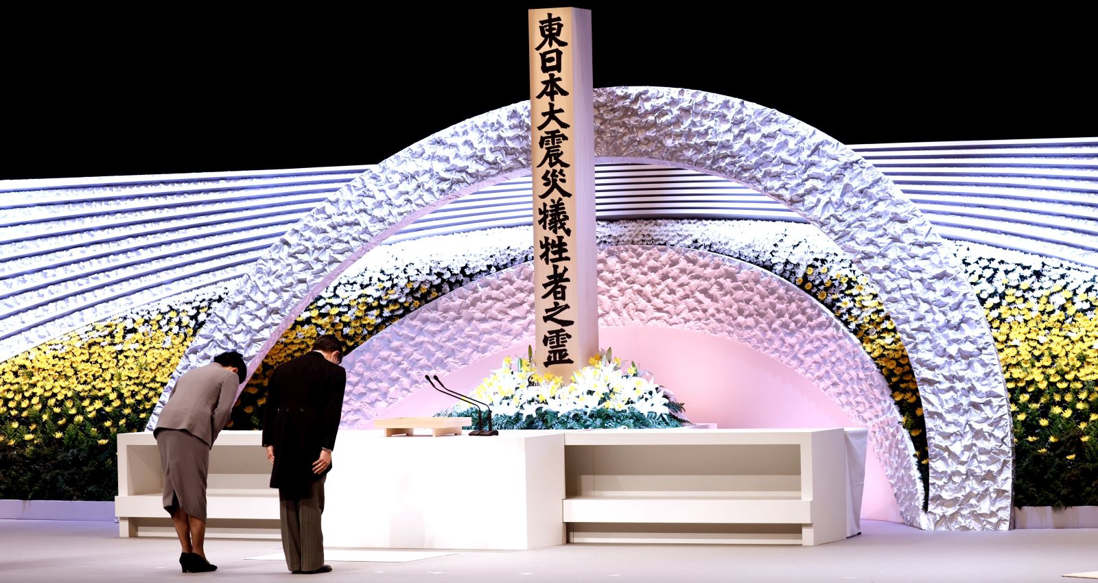 epa09066842 Japan's Emperor Naruhito (R) and Empress Masako (L) bow in front of the altar for victims of the 11 March 2011 earthquake and tsunami at the national memorial service in Tokyo, Japan, 11 March 2021. The ceremony took place on the 10th anniversary of the 9.0 magnitude earthquake which triggered a tsunami and nuclear disaster.  EPA/Behrouz MEHRI / POOL