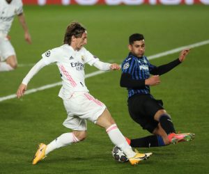 epa09078746 Real Madrid's midfielder Luka Modric (L) vies for the ball with Atalanta's defenedr Cristian Romero (R) during the UEFA Champions League round of 16 second leg soccer match between Real Madrid and Atalanta held at Alfredo Di Stefano stadium, in Madrid, central Spain, 16 March 2021.  EPA/Kiko Huesca