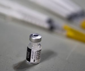 epa09094436 Syringes lie next to a vaccine dose in a vast COVID-19 vaccination center set up inside the national Velodrome in Saint-Quentin-en-Yvelines, near Paris, France, 24 March 2021. French President Emmanuel Macron announced on 23 March to change his strategy and to push for a mass vaccination due to a rise of coronavirus infections in northern France and the Paris region.  EPA/IAN LANGSDON